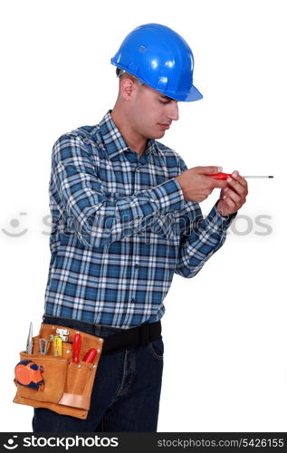 A handyman with a screwdriver.