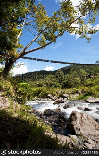 A hanging bridge over a montain stream