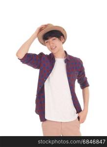 A happy Asian teenager standing in an checkered shirt holdinghis hand on his hat, isolated for white background.