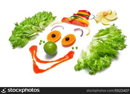 A happy clown made of fruits and vegetables.