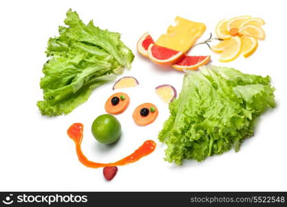 A happy clown made of fruits and vegetables.