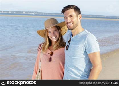 a happy couple enjoying the sea