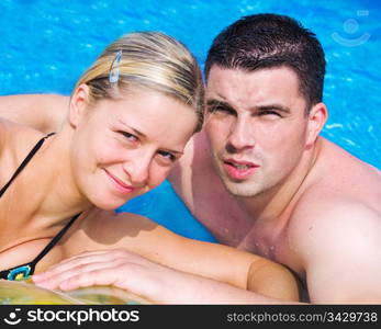 A happy couple enjoying themselves in a pool