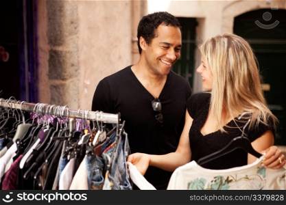 A happy couple shopping at a small street store in Europe
