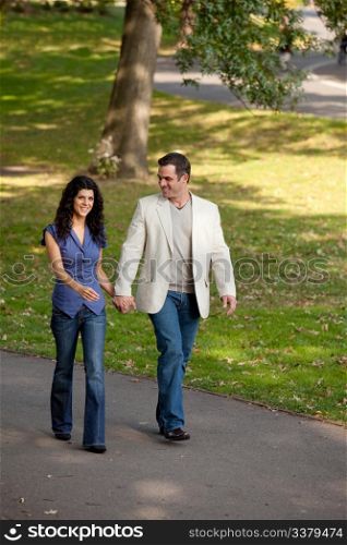 A happy couple walking in the park