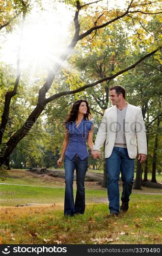 A happy couple walking in the park - looking at each other