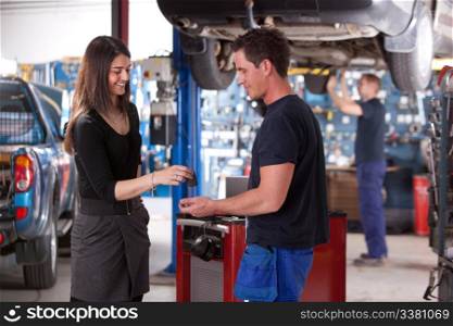 A happy customer delivering a car to a auto repair shop