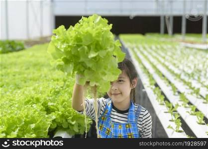 A happy cute girl learning and studying in hydroponic greenhouse farm, education and scientist concept. Happy cute girl learning and studying in hydroponic greenhouse farm, education and scientist concept