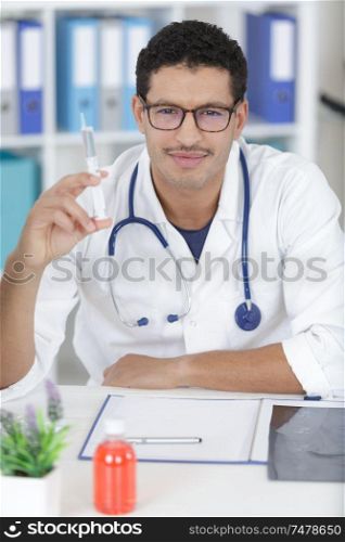 a happy doctor with syringe