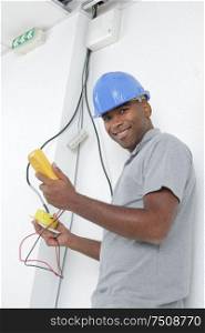 a happy electrican holding multimeter
