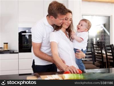 A happy family in the kitchen preparing food and having fun