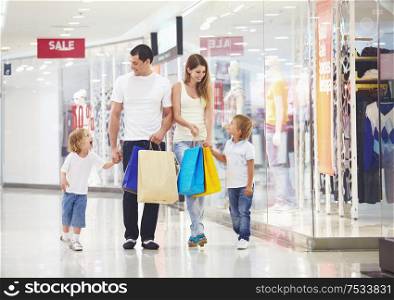 A happy family makes purchases in the store
