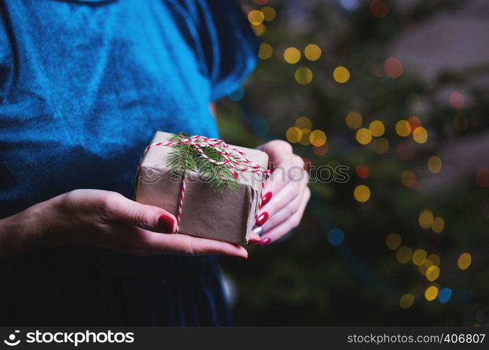 a happy family. mother and daughter with a gift in hand near the Christmas tree. happy New Year's