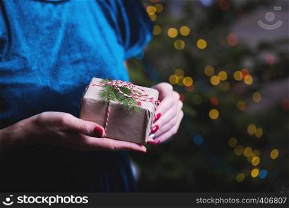 a happy family. mother and daughter with a gift in hand near the Christmas tree. happy New Year's