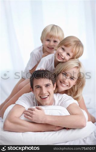 A happy family on a bed in the bedroom