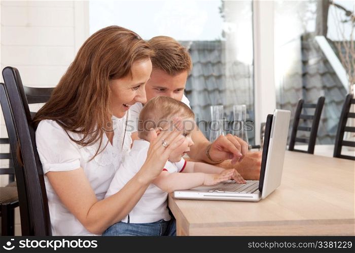 A happy family talking through the computer with video chat
