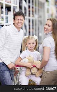 A happy family with a child in a store