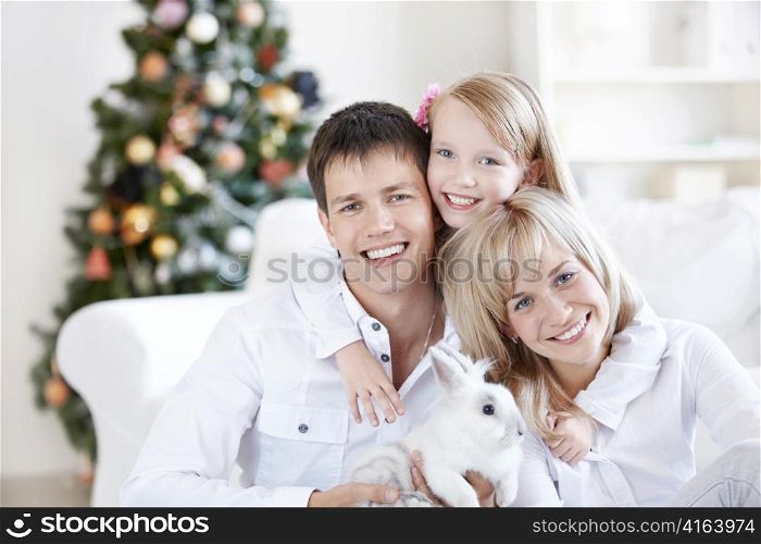 A happy family with a rabbit at home