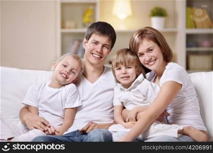A happy family with children at home in the evening