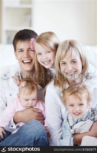 A happy family with kids on the couch at home