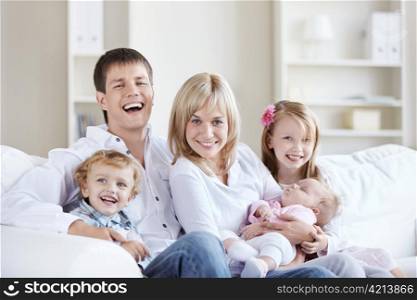 A happy family with three children at home