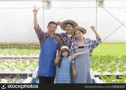 A happy farmer family working in hydroponic greenhouse farm, clean food and healthy eating concept. Happy farmer family working in hydroponic greenhouse farm, clean food and healthy eating concept