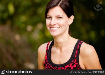 A happy fitness woman in the park - lifestyle portrait