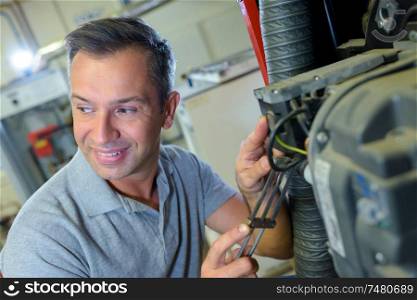 a happy male mechanic in garage