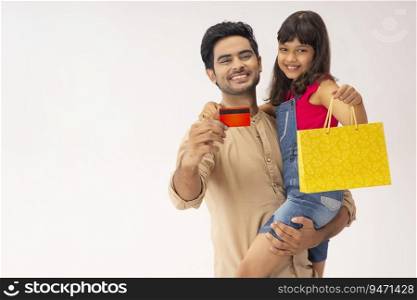 A HAPPY MAN AND DAUGHTER POSING IN FRONT OF CAMERA AFTER SHOPPING