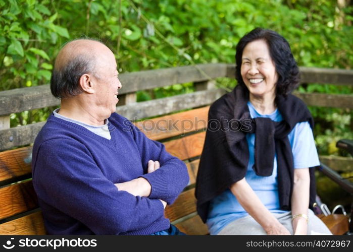 A happy mature asian couple having fun and laughing outdoor