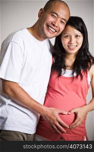 A happy pregnant asian couple expecting their baby