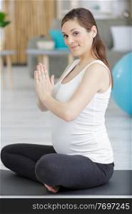 a happy pregnant doing yoga