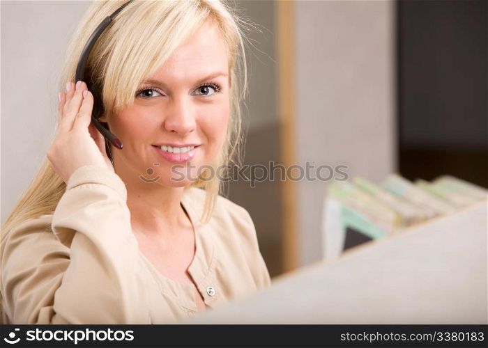 A happy receptionist with a phone headset
