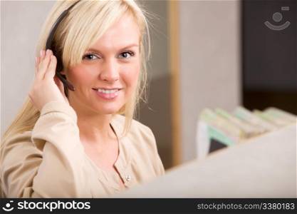 A happy receptionist with a phone headset