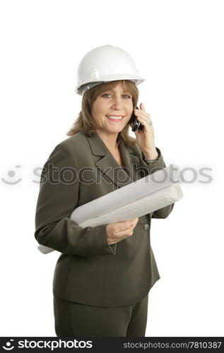 A happy, smiling female architect holding blueprints and talking on her cellphone. Isolated.