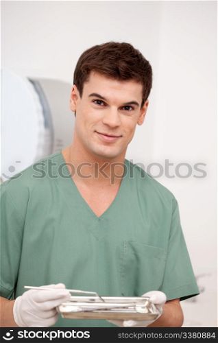 A happy smiling man dentist looking at the camera with a smile