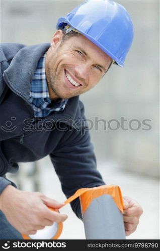 a happy smiling plumber outdoors