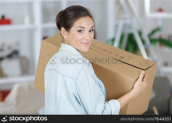 a happy woman holding cardboxes