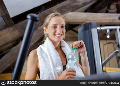 a happy woman refreshing after workout