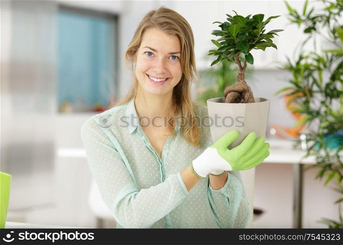 a happy woman with bonsai