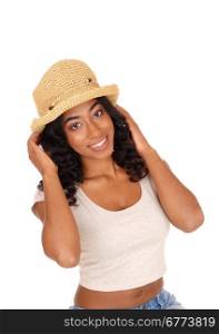 A happy young african american woman is a portrait image holding astraw hat on her black curly hair, isolated for white background.