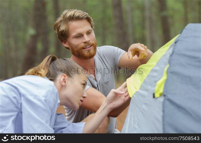 a happy young couple camping