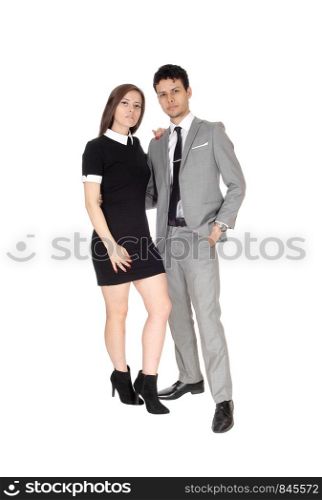 A happy young couple in suit and dress standing smiling isolated for white background in the studio