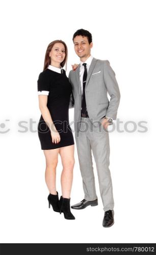 A happy young couple in suit and dress standing smiling isolated for white background