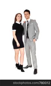 A happy young couple in suit and dress standing smiling isolated for white background