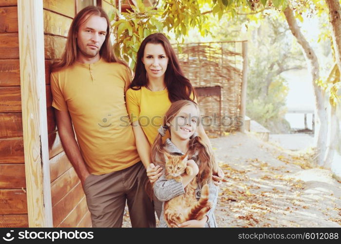 A happy young family with their cat pet