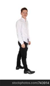A happy young teen age boy standing in a white shirt and black pants isolated for white background, looking at the camera
