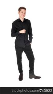 A happy young teen boy standing in a black outfit, smiling, isolatedfor white background