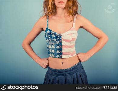 A happy young woman is wearing a stars and stripes top