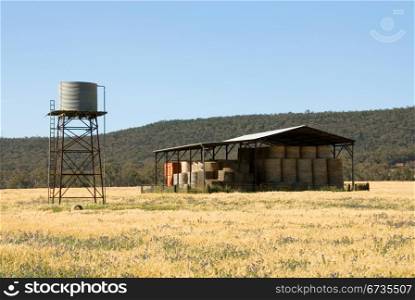 A hay shed and water tank on a farm in South-Western New South Wales, Australia